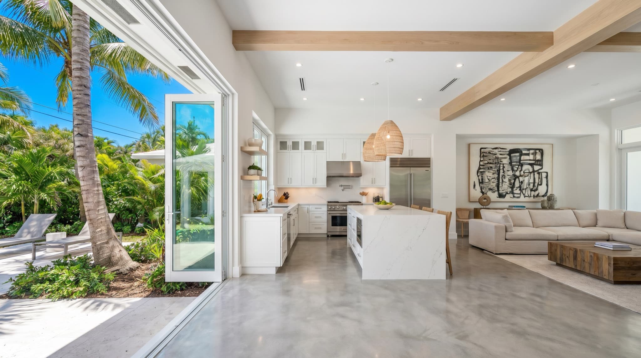 Renovated open-concept South Florida home interior, kitchen and living area, bright, South Florida.