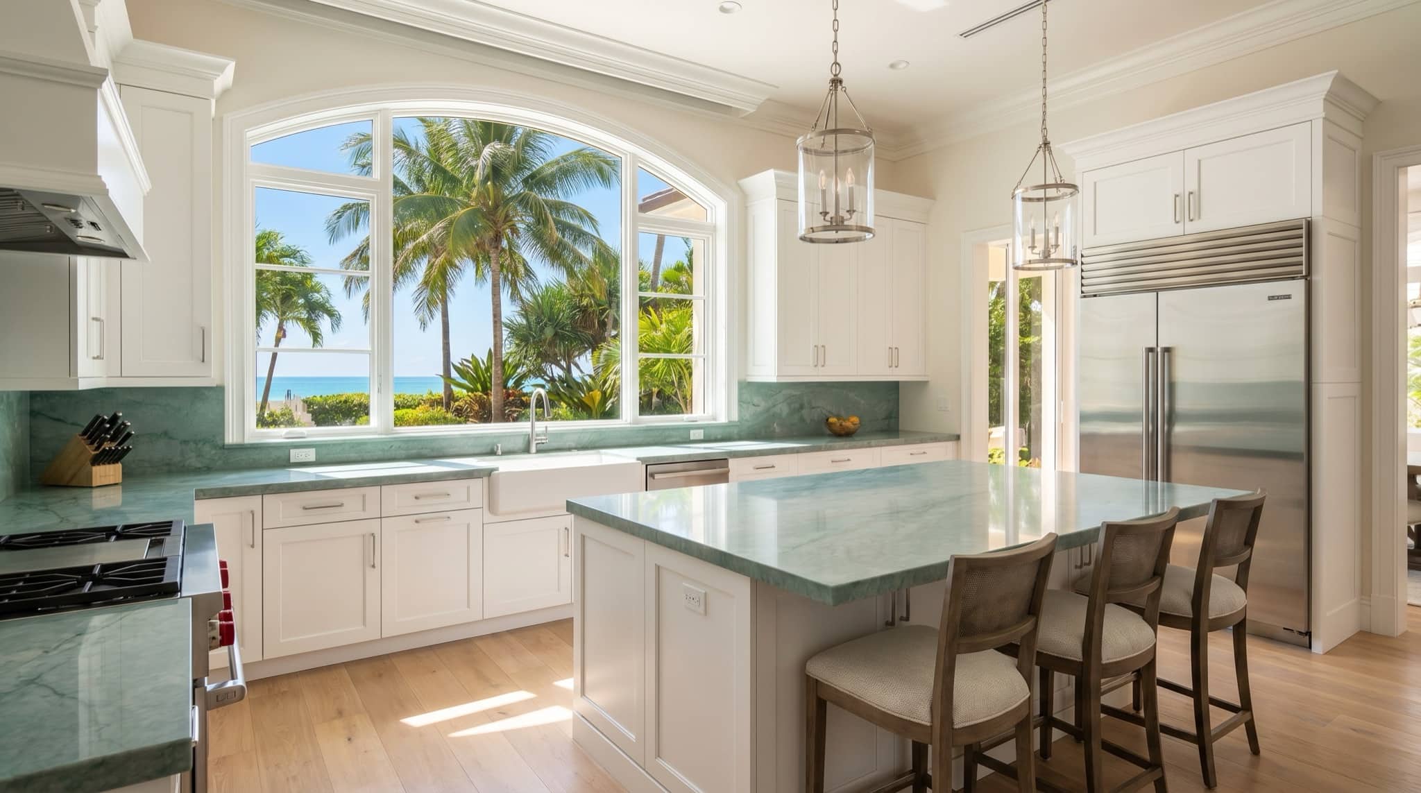 Coastal Florida kitchen with quartz counters and a large window over palms, South Florida.
